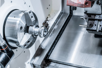 A modern CNC machining center processes the part.