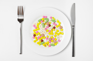Colorful pills in plate