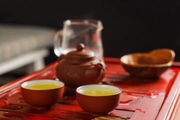 Two bowls with fresh oolong tea on tea desk.