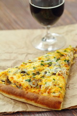 Pizza with chicken meat and mushrooms and glass of dark beer