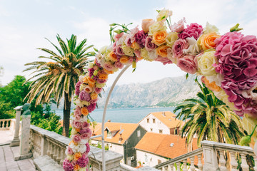 Wedding Arch of hydrangeas and roses. Wedding ceremony in the Bay of Kotor, in Montenegro, in the territory of the church of the Nativity of the Virgin in Prcanj