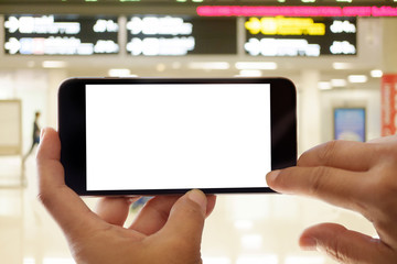 Man taking photo or using Smartphone at gate in airport terminal. For graphic display montage.