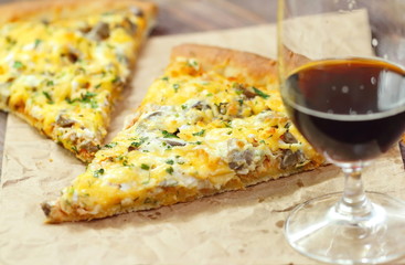 Pizza with chicken meat and mushrooms and glass of dark beer