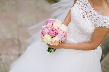 Wedding roses and peonies in the hands of the bride. Wedding in Montenegro.