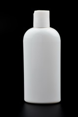 white bottle with makeup on black background