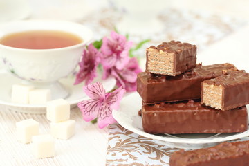 Tea and waffles with chocolate cream and nuts