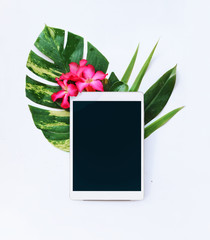 tropical flowers and tablet on a white background - 143750754