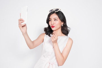 Portrait of beautiful asian fashionable girl taking selfie