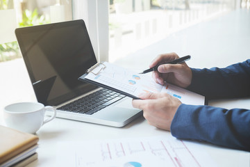 Business concept. Business people discussing the charts and graphs showing the results of their successful teamwork.