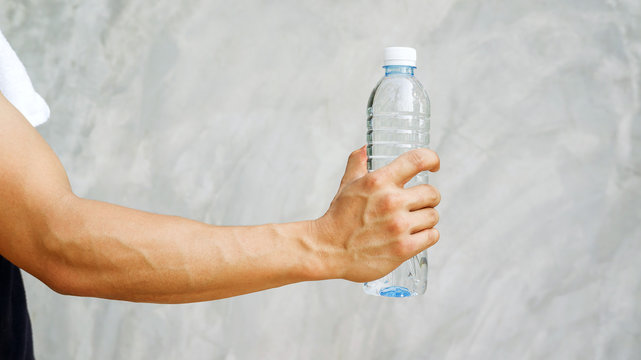 Man holding a bottle of water.