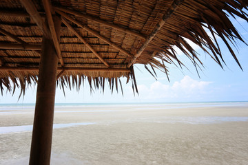 Fototapeta na wymiar leaves roof and beach in summer.