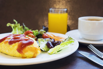 Omelet with fresh salad vegetable and orange juice with coffee breakfast set