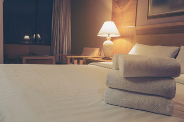 White bedding and towel set in modern hotel