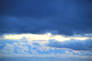 Fototapeta na wymiar Ray of light at sunset on a cloudy sky