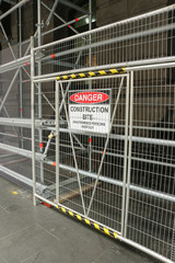 A red, black and white ‘Danger - Construction Site’ warning sign