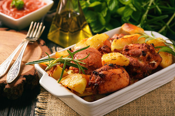 Chicken meat baked with potatoes and spices.