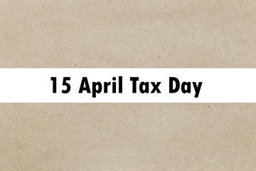 The word 15 april tax appearing behind torn paper. 