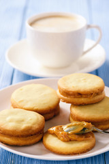 Caramel shortbread cookies on wooden background.