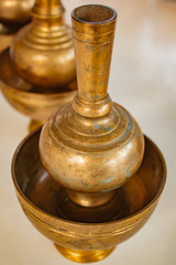 Fototapeta na wymiar A golden brass pour ceremonial water jar.