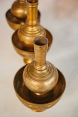 Fototapeta na wymiar A golden brass pour ceremonial water jar.
