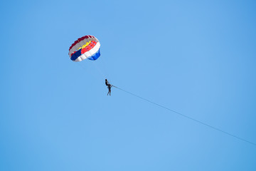 Parasailing against a blue sky.
