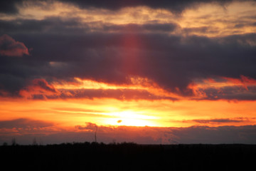 The golden rays of the sun through the clouds
