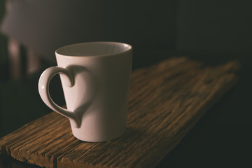Coffee cup with steam set in low light background,Coffee in love concept.Matte style,vintage style.(Selective focus)