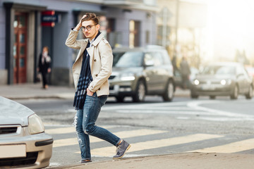 Obraz premium Fashionable man walking on the street with blur background