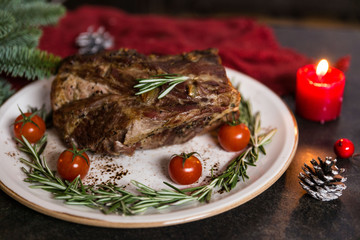 Grilled pork steaks with cherry tomatoes and rosemary on plate