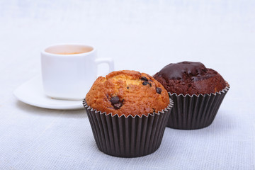 Fresh homemade muffin, cake and white cup of Cappuccino on white background.