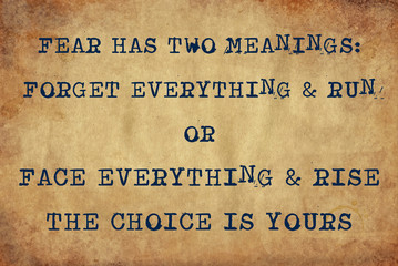 Inspiring motivation quote of fear has two meanings: forget everything & run or face everything & rise.  the choice is yours with typewriter text. Distressed Old Paper with Typing image.