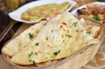 Garlic and coriander naan on a basket