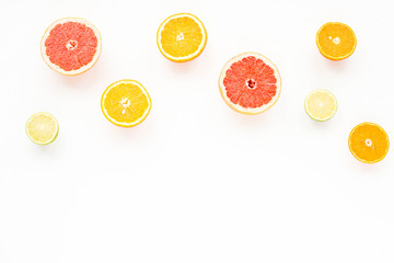 Fruit composition. Fresh colorful citrus fruits on white background. Flat lay, mock up, top view