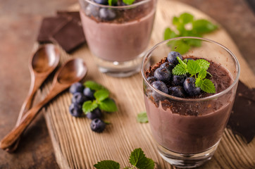 Fototapeta na wymiar Chocolate pudding with berries and herbs