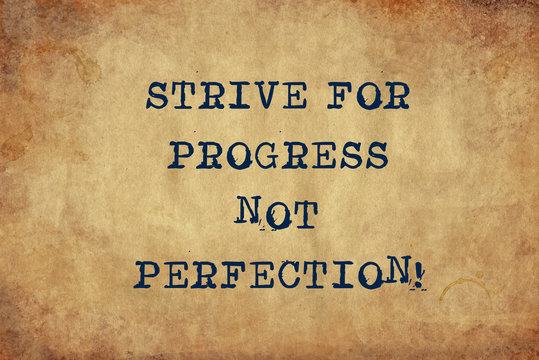 Inspiring motivation quote of strive for progress not perfection with typewriter text. Distressed Old Paper with Typing image.
