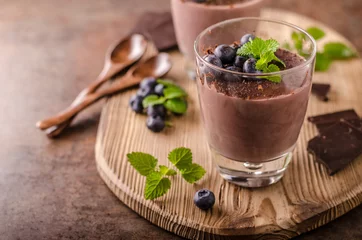 Selbstklebende Fototapeten Chocolate pudding with berries and herbs © Stepanek Photography