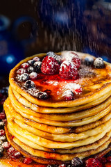 Pancakes with berries and sugar, close-up