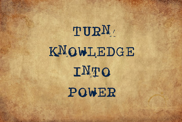 Inspiring motivation quote of turn knowledge into power with typewriter text. Distressed Old Paper with Typing image.