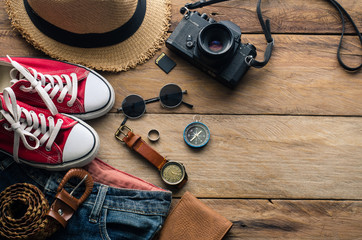 Travel accessories and costume on wooden floor