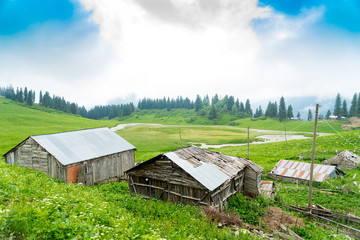 View of a wooden mountain cabin with mountains in the background