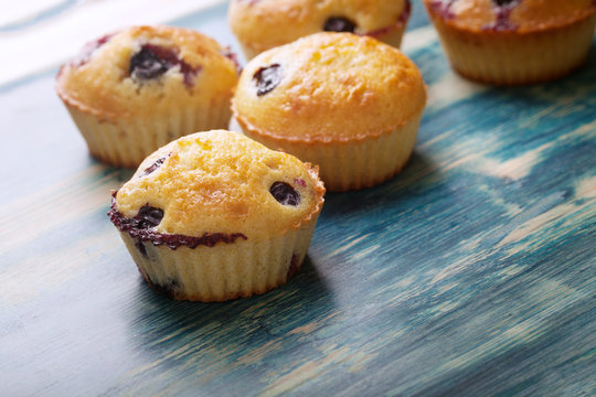 muffin with blueberries on a wooden table. sweet pastries on the board