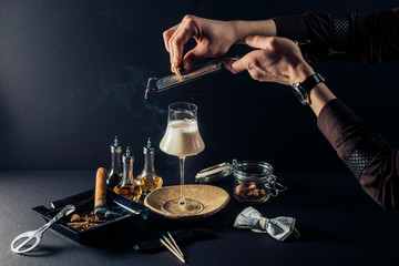 colorful cocktail with a cigar on a beautiful composition with drops and beautiful colors