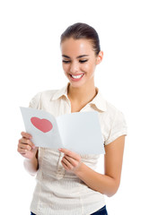 Fototapeta premium Young happy woman with valentine card, isolated