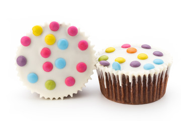 Multiple colorful decorated muffins on a white background.