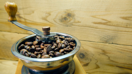 Fototapeta na wymiar manual coffee grinder with coffee beans