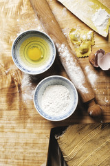 making ravioli, cutting the dough, stuffing pasta, raw ingredients like flour and eggs.
