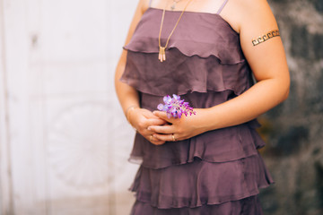 wisteria branch in the hands of a girl in a purple dress