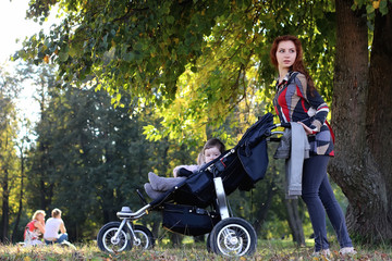Fototapeta na wymiar women walk stroller summer