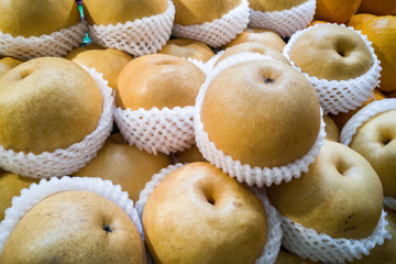 Whole yellow nashi pear wrapped in protective foam