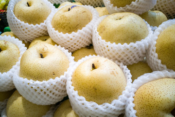 Whole yellow gong pear wrapped in protective foam